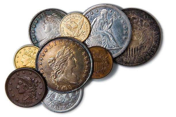 Rare Coin Photo Close-up image of coins with a shallow depth of field. Coins that were pulled out of savings account or inheritance because of economic hardship. Variance of silver, cold, copper currency from different countries.